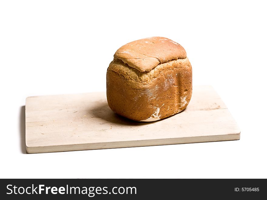 Loaf of homemade white bread on cutting board - isolated on white background