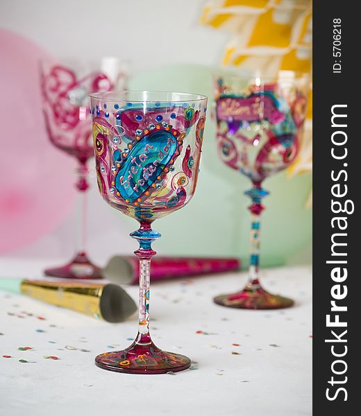 Colorful glasses, party decorations at background. Colorful glasses, party decorations at background
