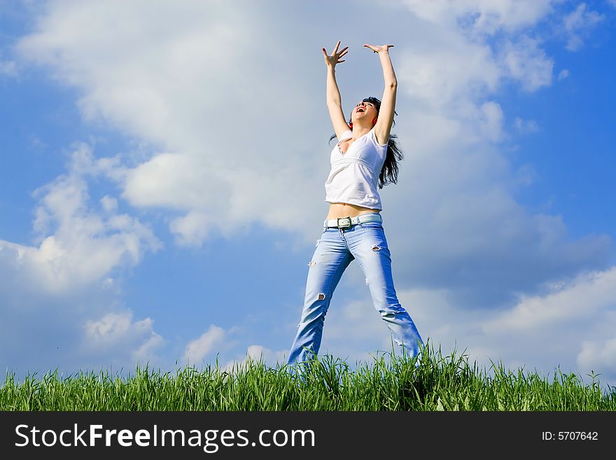 Expressive woman jumping on green grass. Expressive woman jumping on green grass