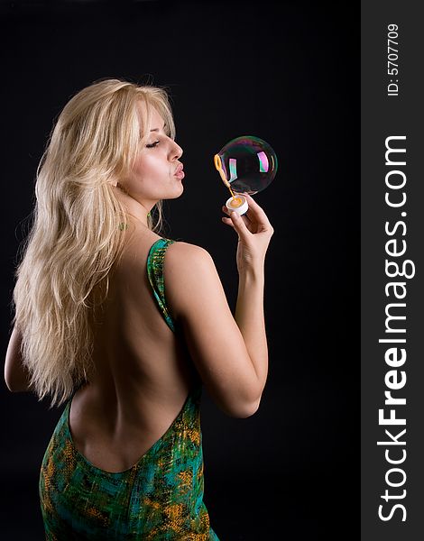 Girl with bubble on black background