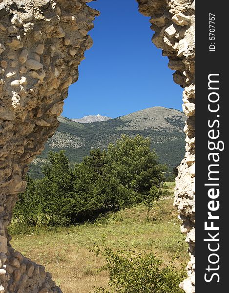 Nature view trough an antique stone wall. Nature view trough an antique stone wall