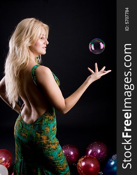 Girl with ballons and bubbles on black background