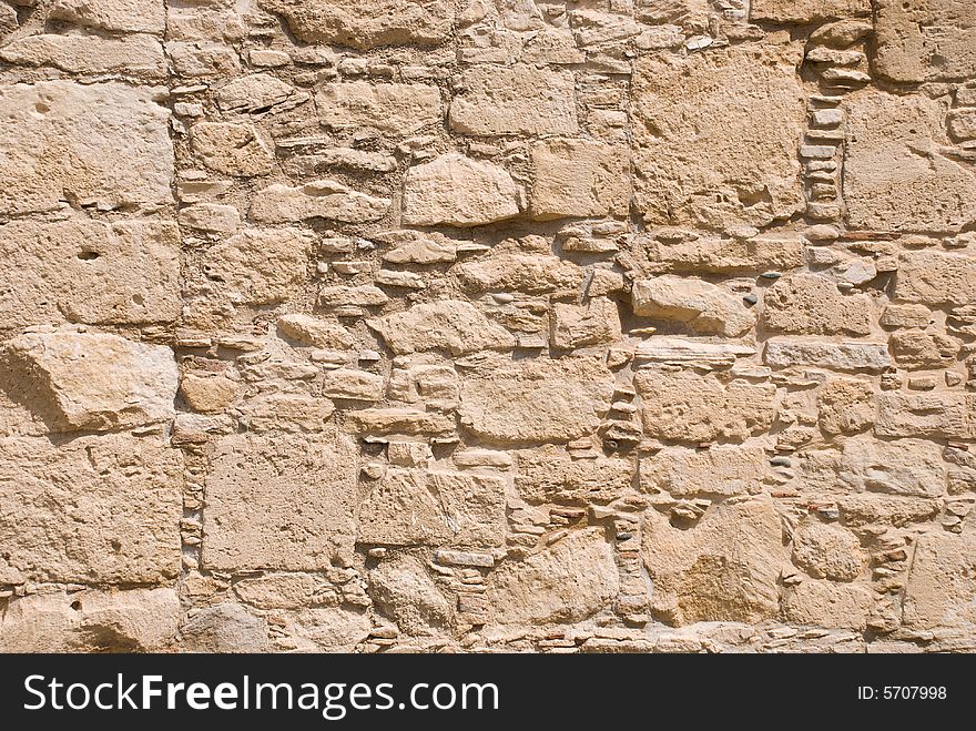 Stone wall from rough sandstone with cement