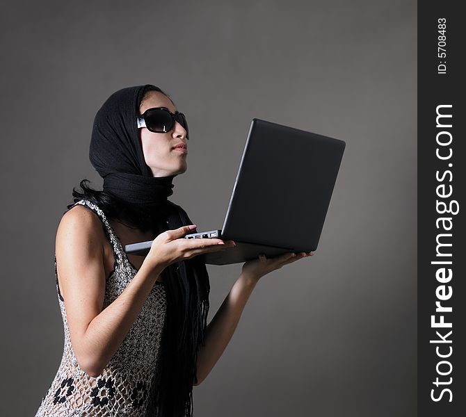 Portrait of classy woman with sunglasses holding laptop. Portrait of classy woman with sunglasses holding laptop