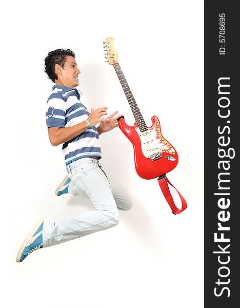 Teen jumping with guitar