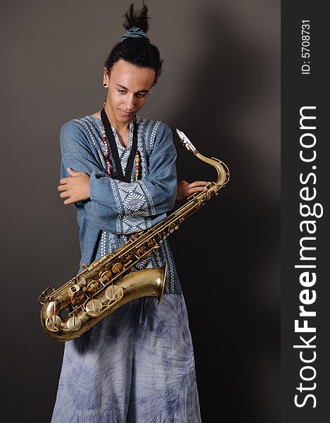 Portrait of young musician standing with saxophone. Portrait of young musician standing with saxophone