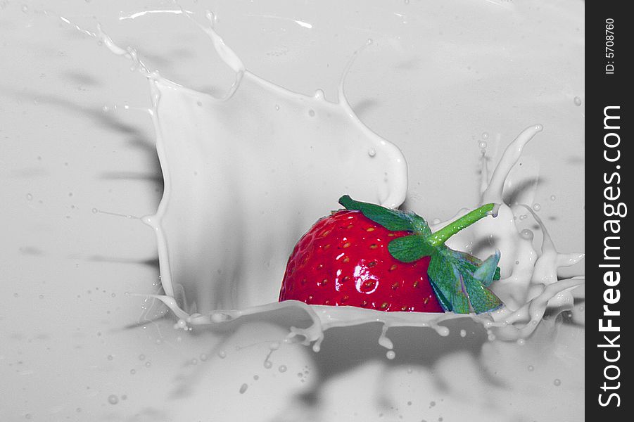 Strawberry falling into creamy milk. Strawberry falling into creamy milk