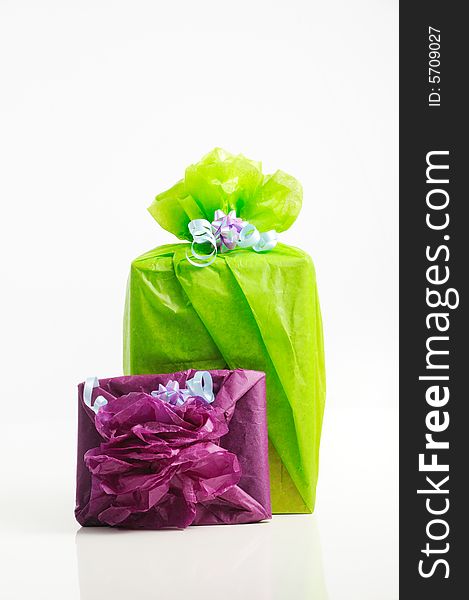 Two gift boxed wrapped in colorful papers - isolated. Two gift boxed wrapped in colorful papers - isolated