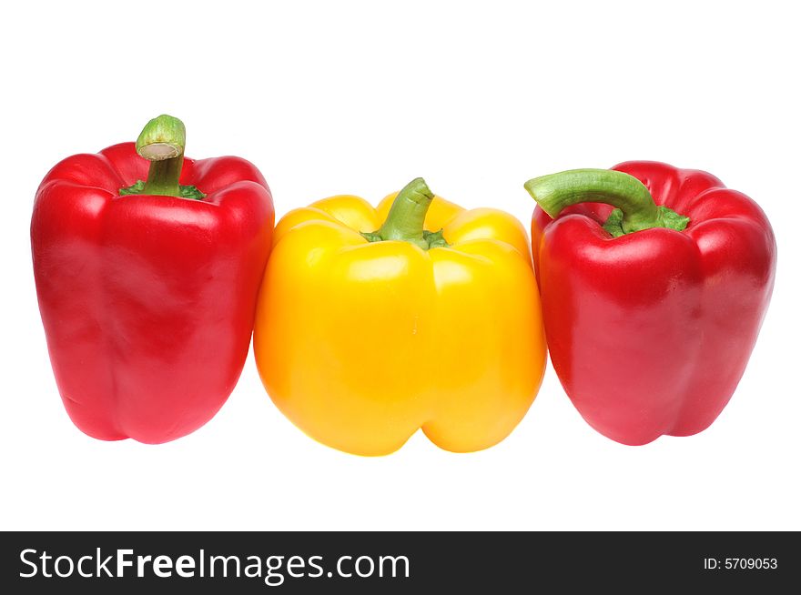 Red and yellow peppers in row on pure white background