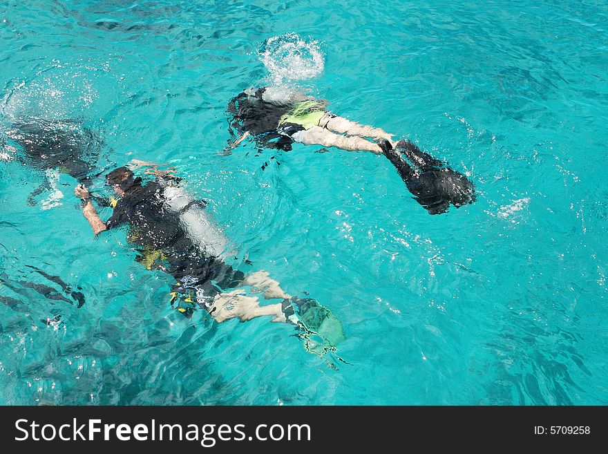Group of scuba divers under water.