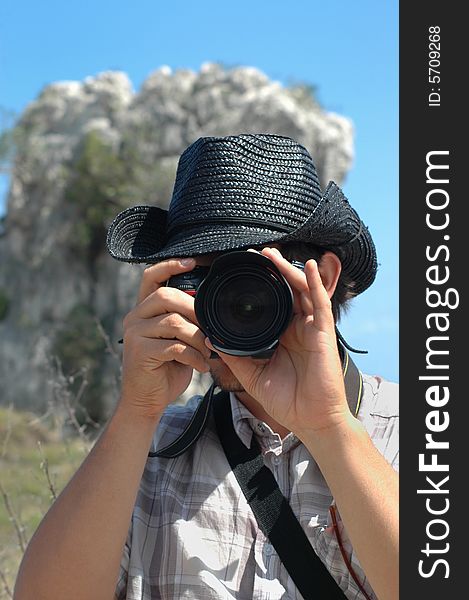 Portrait of young man using professional camera in nature background. Portrait of young man using professional camera in nature background