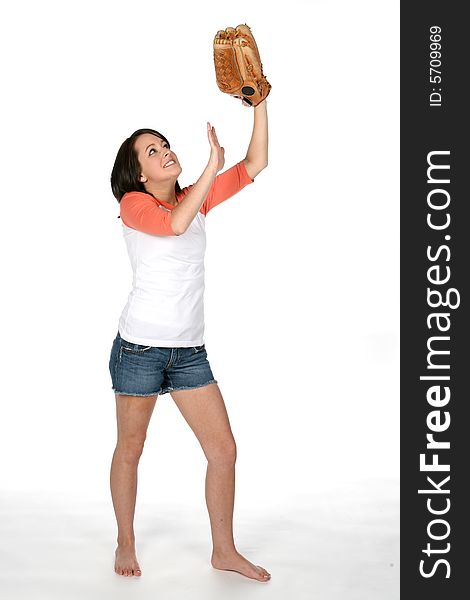 Teenage girl holding softball glove in the air as if catching a ball