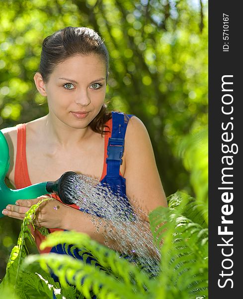 Attractive woman doing work in her garden. Attractive woman doing work in her garden