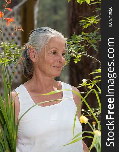 Portrait of attractive senior woman in garden. Portrait of attractive senior woman in garden