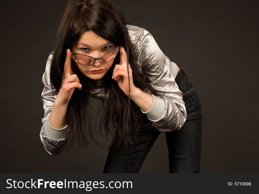 Young girl in fashion sunglasses, isolated on black background