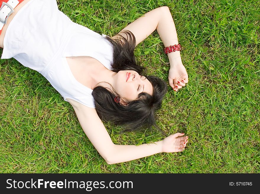 Pretty woman rest on the green grass. Pretty woman rest on the green grass