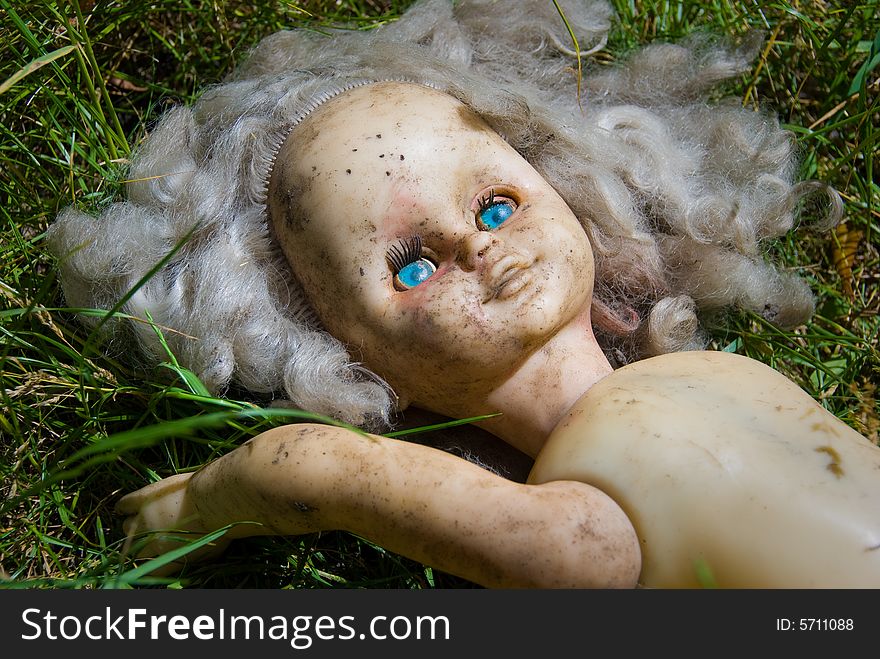 The thrown out blonde doll with blue eyes. The thrown out blonde doll with blue eyes