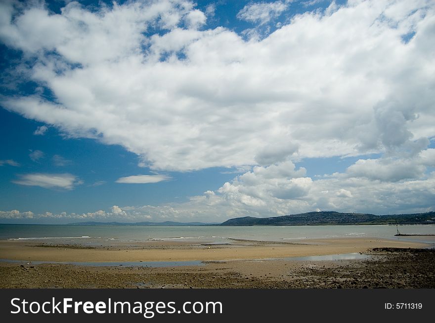 The clouds sweep over the beach at rhos-on-sea in north wales in the united kingdom. The clouds sweep over the beach at rhos-on-sea in north wales in the united kingdom