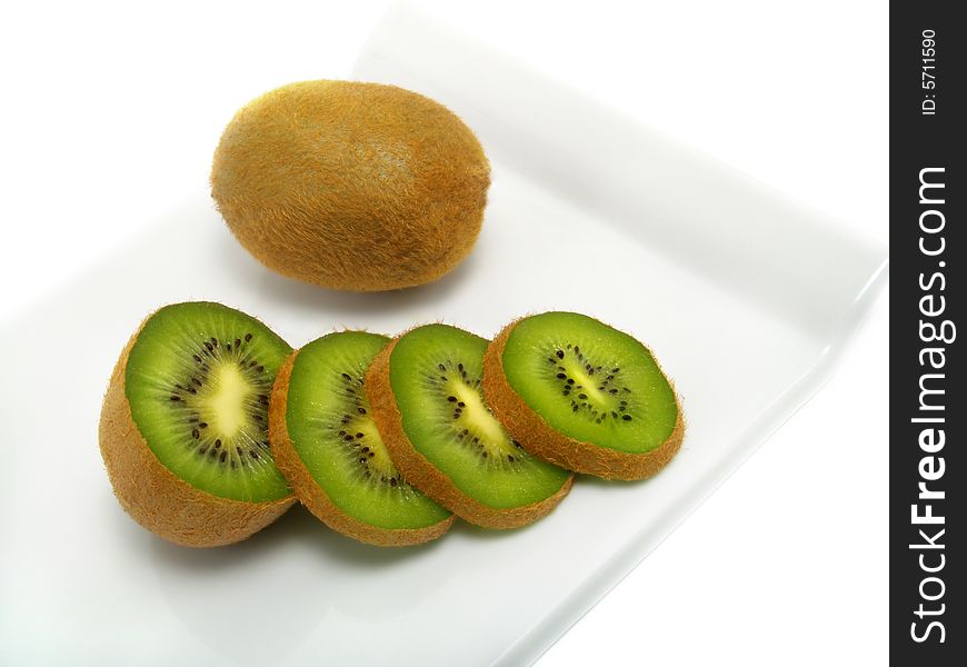 Sliced and whole fresh ripe kiwi on cutting board and isolated on white background. Sliced and whole fresh ripe kiwi on cutting board and isolated on white background