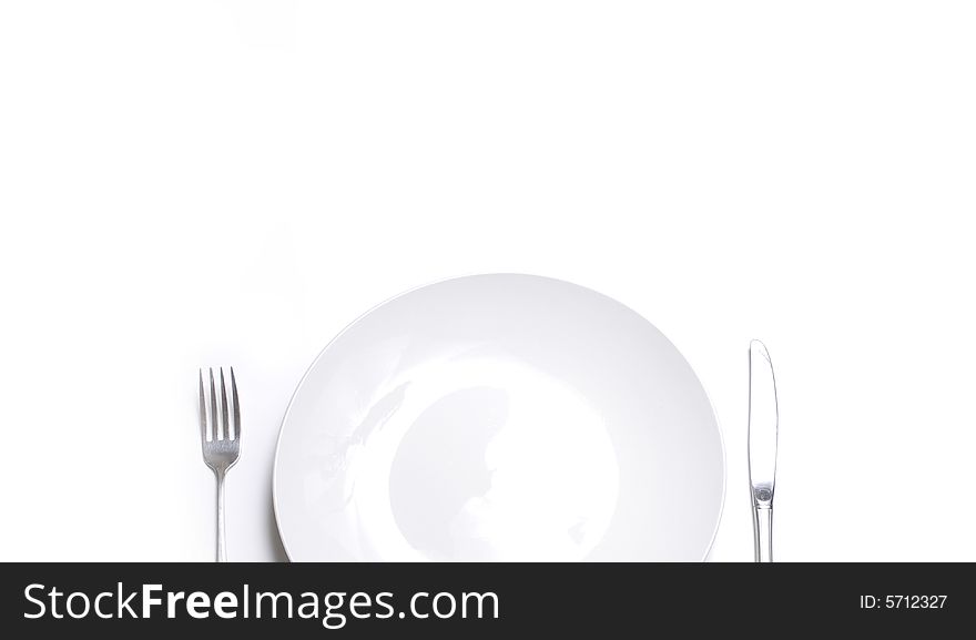 Knife and fork silverware with white plate on white background. Knife and fork silverware with white plate on white background