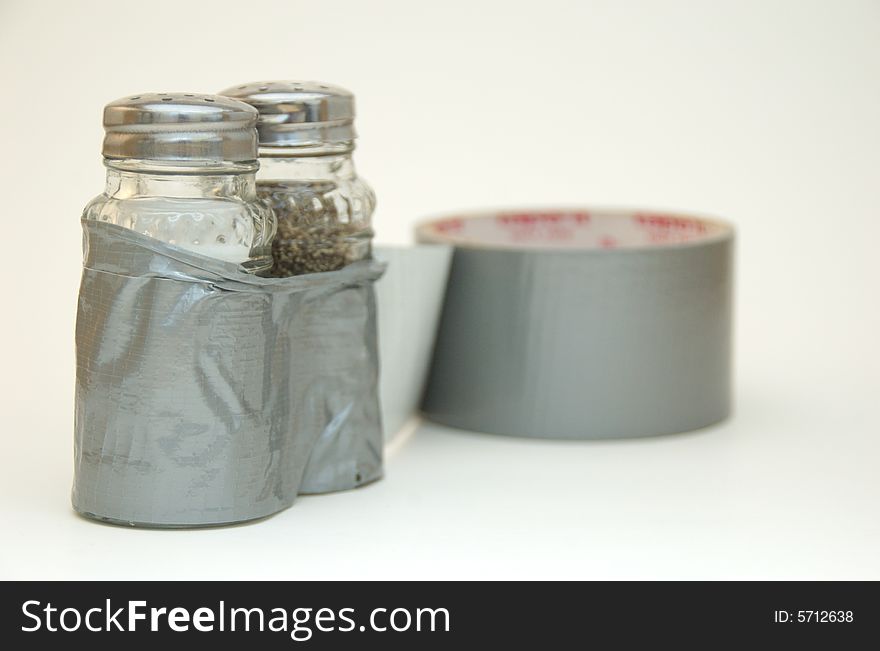 A salt and pepper shaker stuck together with ducttape.  Several concepts including breaking free from ordinary cooking, and more. A salt and pepper shaker stuck together with ducttape.  Several concepts including breaking free from ordinary cooking, and more.