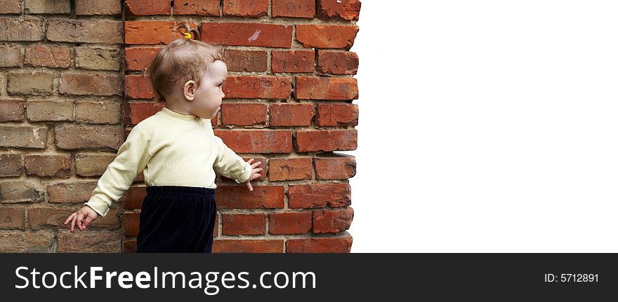 An image of baby-girl near a orange wall