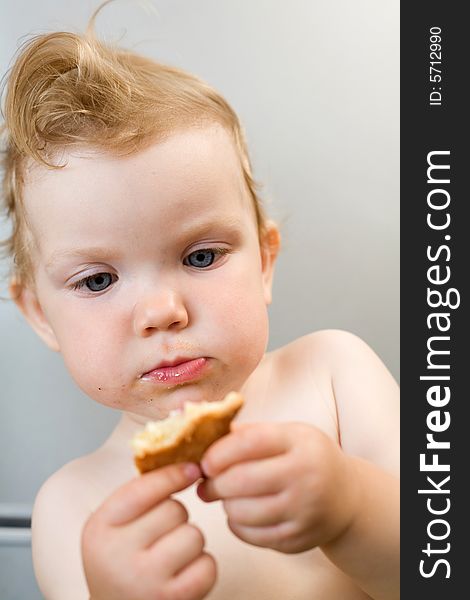 An image of baby eating white bread. An image of baby eating white bread