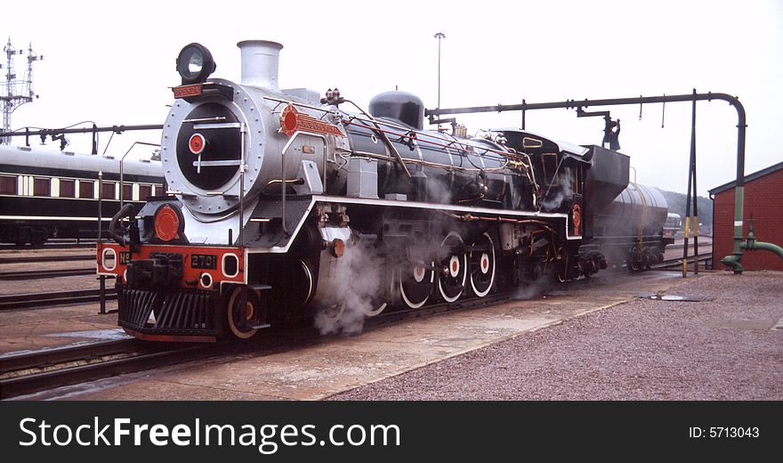 Steam locomotive taking in water