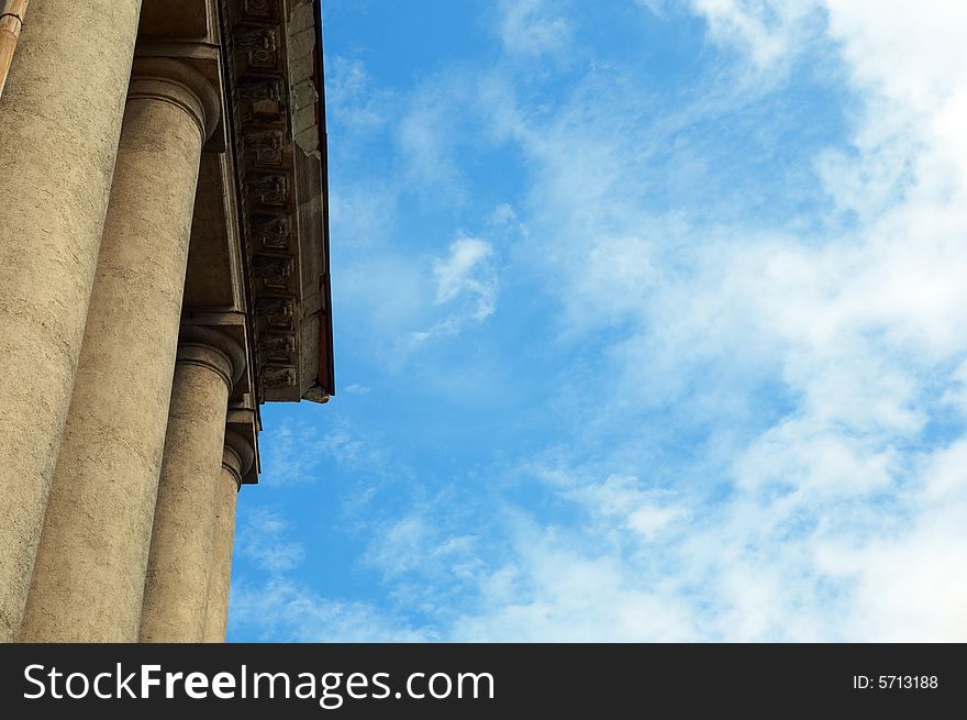 Column construction under blue sky with clouds
