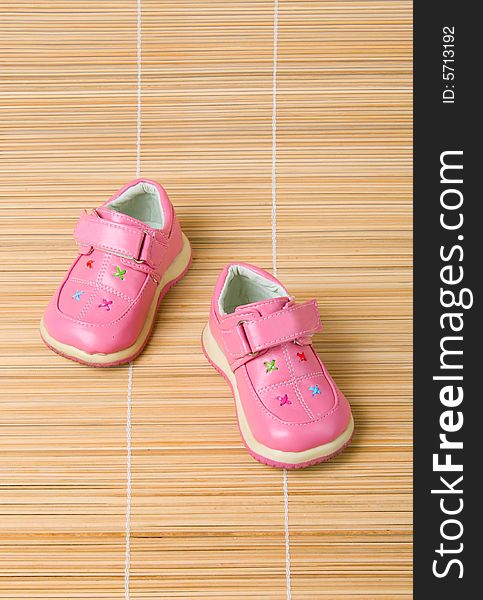 Pink children's shoes #2 on bamboo background