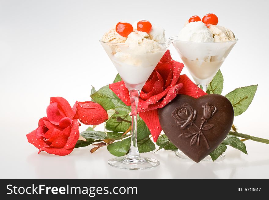 Ice-cream with a cherry in a glass on a white background. Ice-cream with a cherry in a glass on a white background.