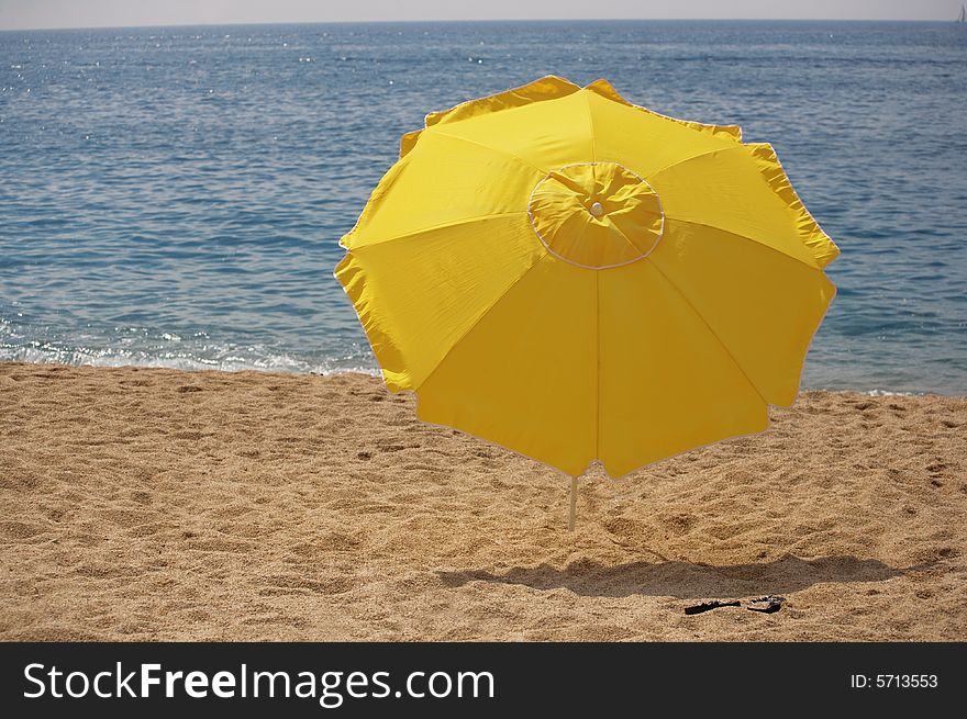 A photo of beach umbrella on the sand. A photo of beach umbrella on the sand