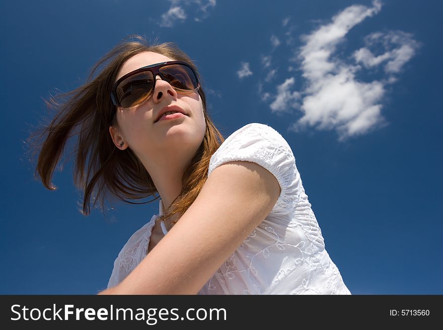 Woman sitting on roof, deep blue sky over her head. Woman sitting on roof, deep blue sky over her head