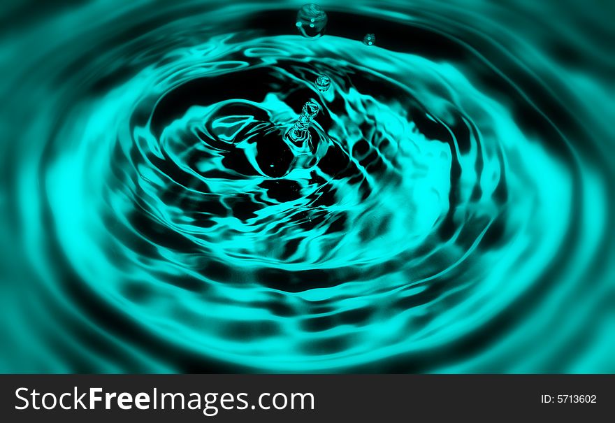 A drop of water splashing in a pool