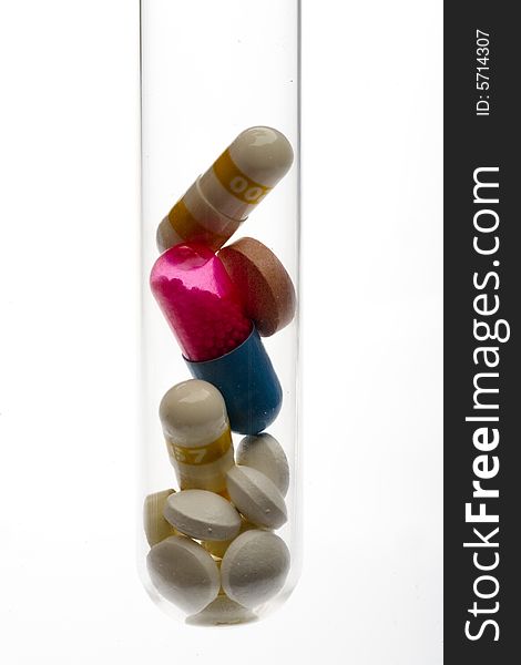 Pills and capsules in a test tube. Pills and capsules in a test tube