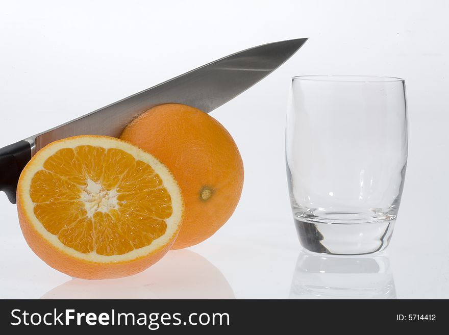 Oranges, knife and glass on a white background. Oranges, knife and glass on a white background