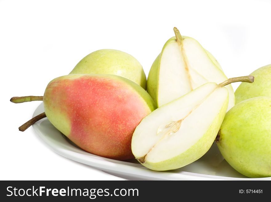 Fresh pears on a plate on bright background. Fresh pears on a plate on bright background