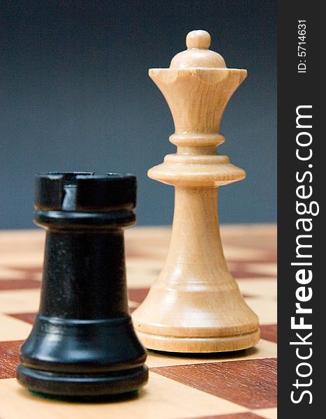 Chess - rook and queen on the board, blue background