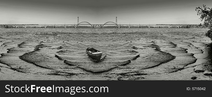 Black-white photo with the symmetric rhythm of waves and abandoned boat