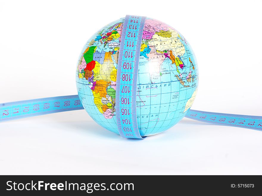 Measuring tape stretched across globe on white