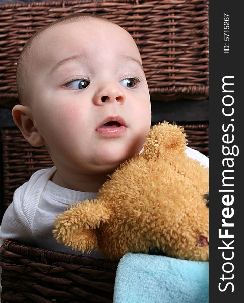 Six month old baby sitting infront of wooden drawers. Six month old baby sitting infront of wooden drawers