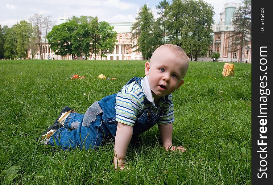 The kid playing on a grass in park