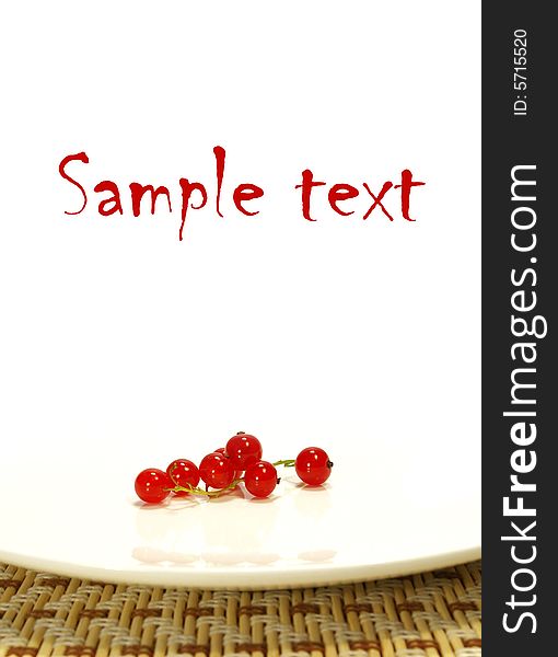 Red currant on a white plate