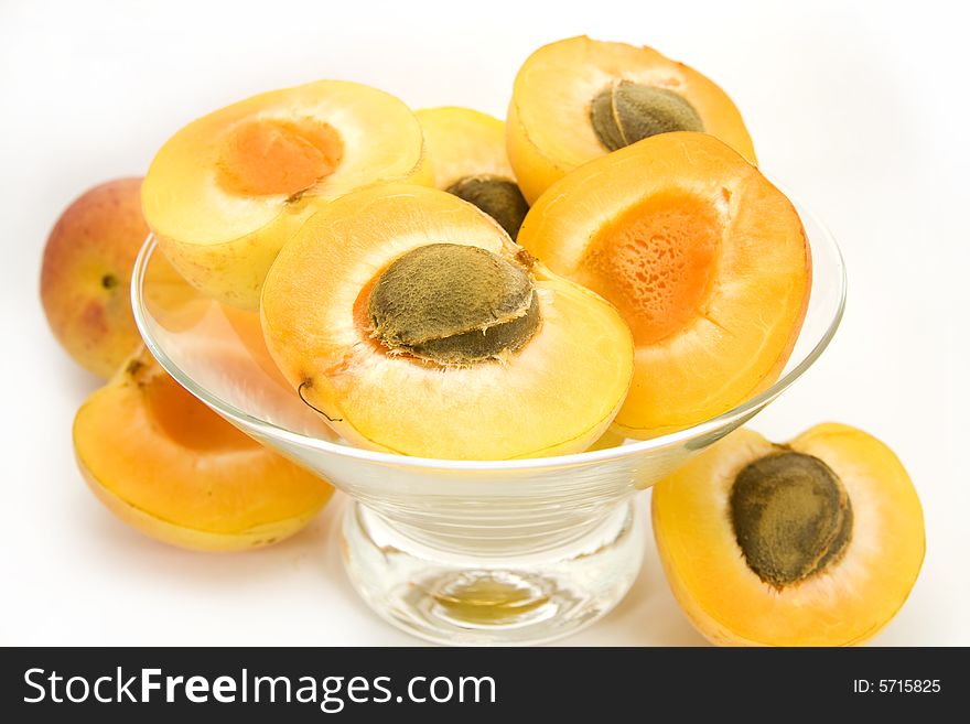 Apricots in bowl isolated on white background