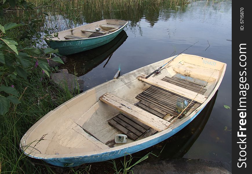 Two old boats at lake coast