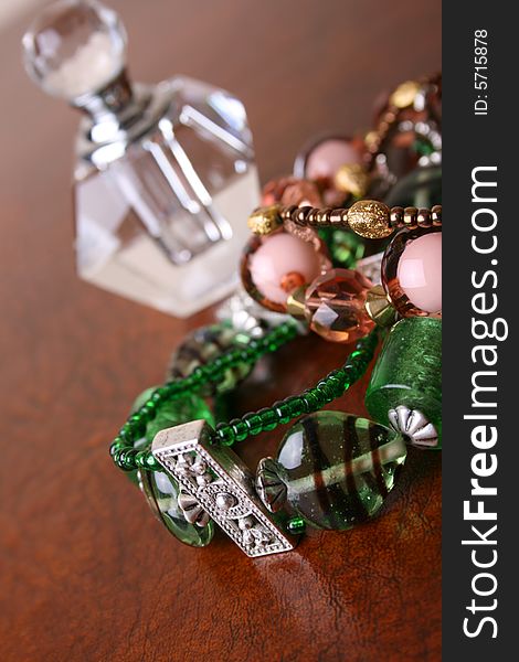 Green and Orange beaded jewelery with perfume bottle
