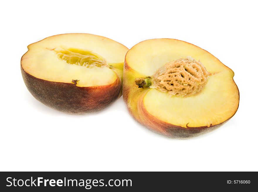 Halves of peach isolated on white. Halves of peach isolated on white