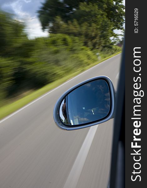 Detail of a car driving on a country road