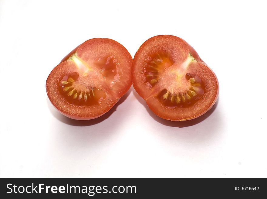 Two halfs of red tomato isolated on white. Two halfs of red tomato isolated on white