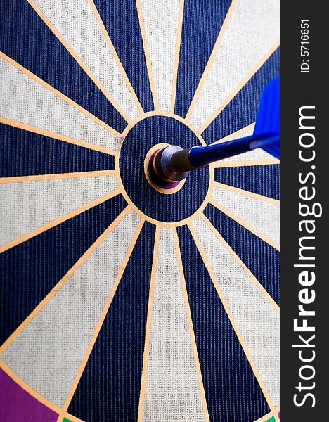 A magnetic dart board with darts at the center (bullseye)